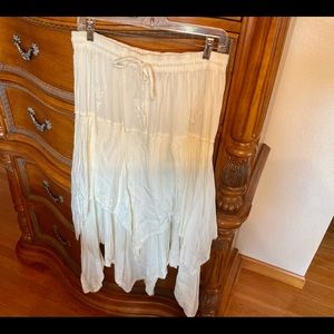 Off white layered skirt with shark bite hem
